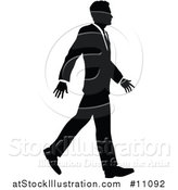 Vector Illustration of a Black and White Silhouetted Business Man Walking by AtStockIllustration