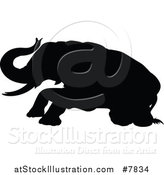 Vector Illustration of a Black Silhouetted Elephant Getting up by AtStockIllustration