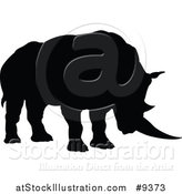 Vector Illustration of a Black Silhouetted Rhinoceros by AtStockIllustration