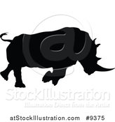 Vector Illustration of a Black Silhouetted Rhinoceros Charging by AtStockIllustration