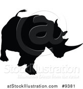 Vector Illustration of a Black Silhouetted Rhinoceros Charging by AtStockIllustration