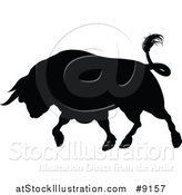 Vector Illustration of a Silhouetted Black Bull Charging by AtStockIllustration