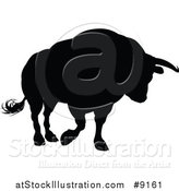 Vector Illustration of a Silhouetted Black Bull Charging by AtStockIllustration