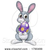 Vector Illustration of Easter Bunny Rabbit with Easter Egg by AtStockIllustration