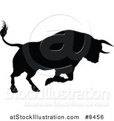 Vector Illustration of a Black Silhouetted Bull Charging by AtStockIllustration