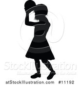 Vector Illustration of a Black Silhouetted Little Girl Throwing a Ball by AtStockIllustration