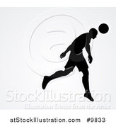 Vector Illustration of a Black Silhouetted Male Soccer Player Head Passing a Ball, over Gray by AtStockIllustration