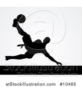 Vector Illustration of a Black Silhouetted Male Soccer Player Kicking over Gray by AtStockIllustration