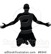Vector Illustration of a Black Silhouetted Male Soccer Player Kneeling or Jumping by AtStockIllustration