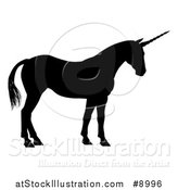 Vector Illustration of a Black Silhouetted Mythical Unicorn Standing by AtStockIllustration