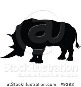 Vector Illustration of a Black Silhouetted Rhinoceros by AtStockIllustration
