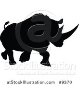 Vector Illustration of a Black Silhouetted Rhinoceros Charging by AtStockIllustration