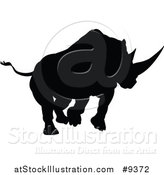 Vector Illustration of a Black Silhouetted Rhinoceros Charging by AtStockIllustration