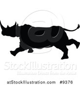 Vector Illustration of a Black Silhouetted Rhinoceros Charging by AtStockIllustration