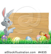 Vector Illustration of a Gray Bunny Pointing to a Wood Sign with Grass and Easter Eggs by AtStockIllustration