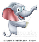 Vector Illustration of a Happy Elephant Pointing to a Sign by AtStockIllustration