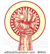 Vector Illustration of a Retro Red and Yellow Engraved Revolutionary Fist over a Circle of Rays by AtStockIllustration