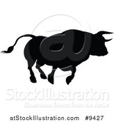 Vector Illustration of a Silhouetted Black Bull Charging by AtStockIllustration